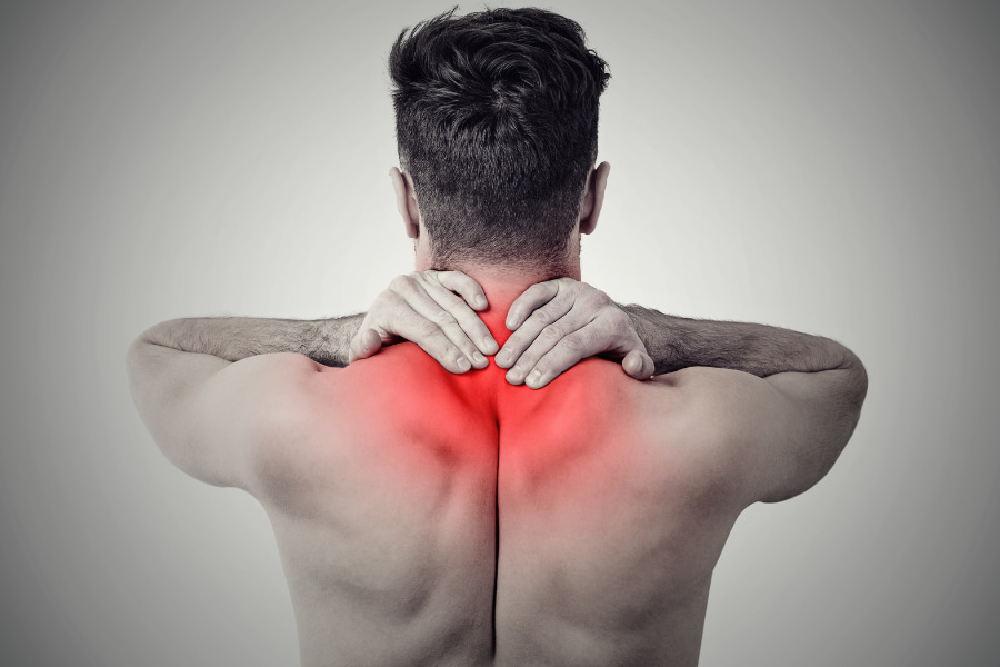 black and white image of a man experiencing neck pain