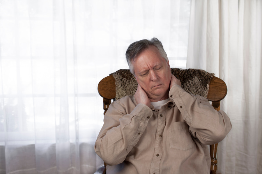 older man feeling discomfort in neck