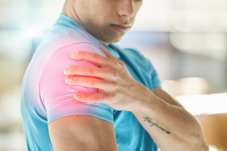 man feeling shoulder pain 