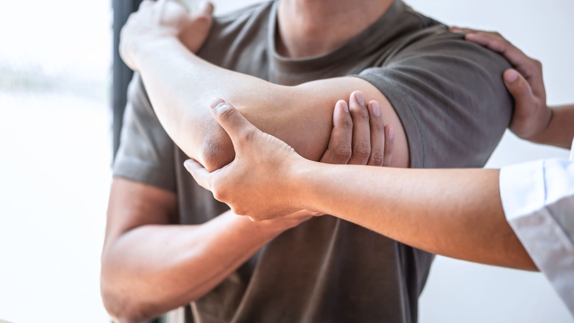 Man testing his arm's range of motion