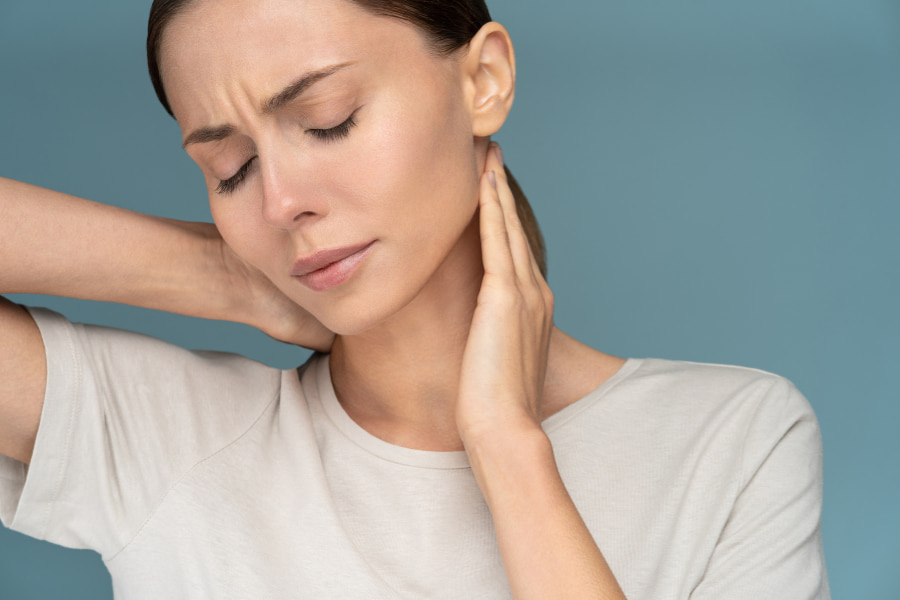 Woman holding her neck