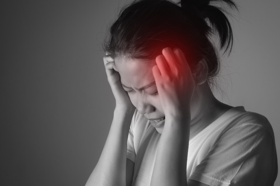 black and white image of a woman experiencing a headache