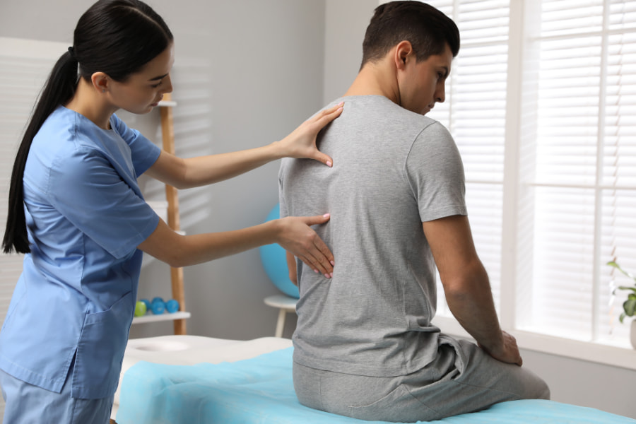 nurse examining a patient's back