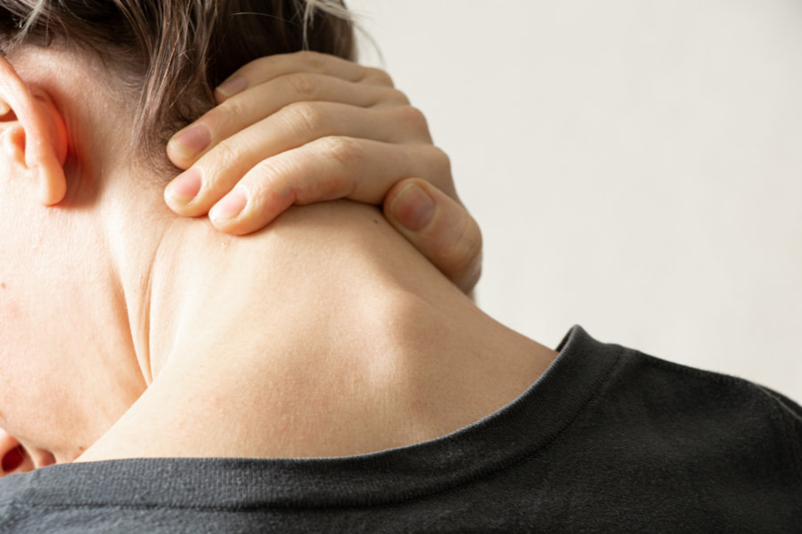 image of man looking down and grabbing his neck