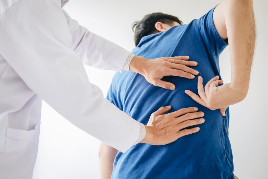image of a doctor examining their patient's back