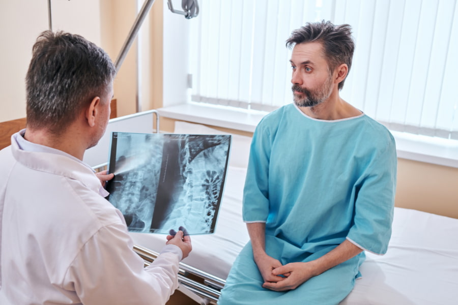 image of a neurosurgeon examining a patient's x-ray results