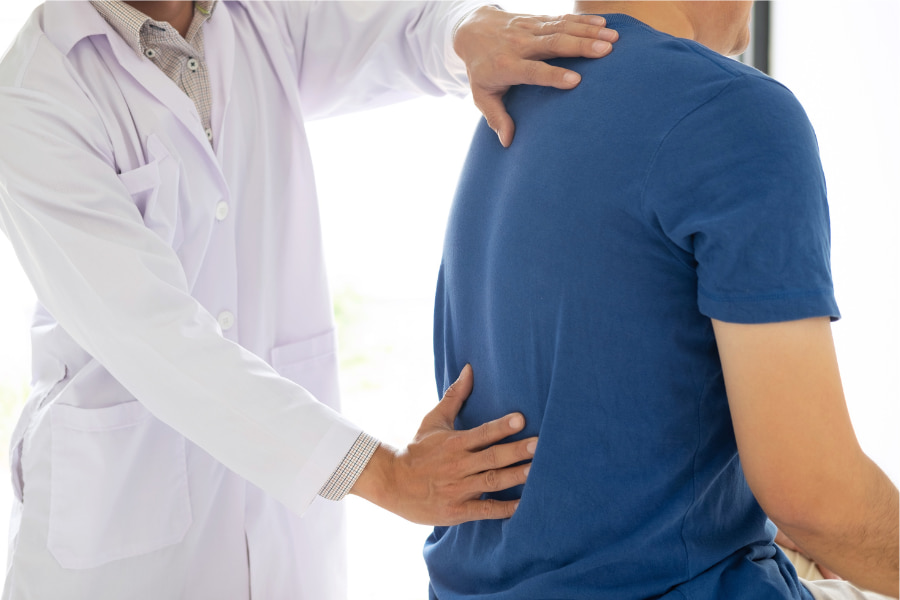 image of a man getting his back examined by a neurosurgeon